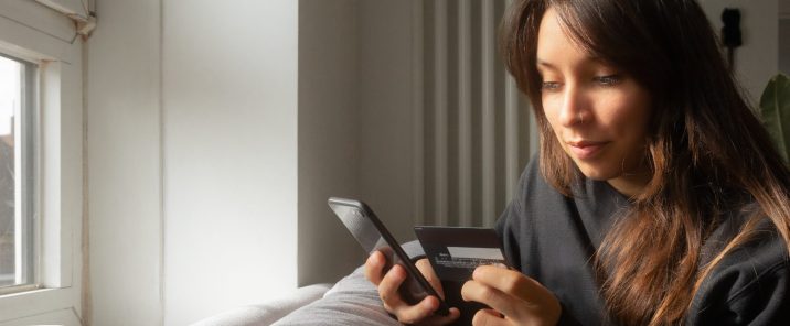 Woman making payment online with smartphone